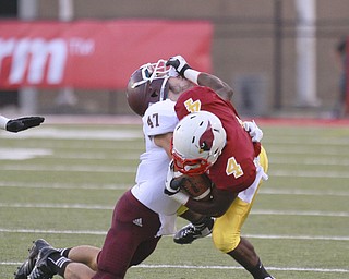 ROBERT K. YOSAY | THE VINDICATOR..Gaining a tough first down in first quarter action as Mooney (4) Marcus McWilson puts a stiff arm to Boardmans (#47 Brock Hull) .Bdm @ Mooney - Stambaugh Stadium... - -30-..