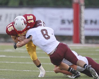 ROBERT K. YOSAY | THE VINDICATOR..Brought down during first quarter action is Mooneys' (15) Denver Martin after a short gain by Boardmans (8) Ryan Savage..Bdm @ Mooney - Stambaugh Stadium... - -30-..