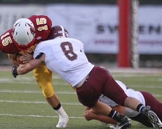 ROBERT K. YOSAY | THE VINDICATOR..Brought down during first quarter action is Mooneys' (15) Denver Martin after a short gain by Boardmans (8) Ryan Savage..Bdm @ Mooney - Stambaugh Stadium... - -30-..