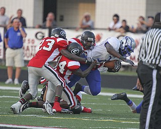 m D LEwis The Vindicator Hubbard's Larry Scott(3) is stopped by a host of Girard defenders at Girard Friday 8-31-12.