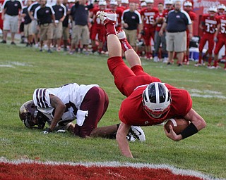 .IMG 8873: Niles Quarterback Stefan Yuhas (40) gets tripped up as he crosses the goal line by John Helms (23) of Liberty with 46 seconds to go in the first quarter of Friday nights matchup at Niles Mckinley High School in Niles. ÊDustin Livesay Ê| ÊThe Vindicator 8/31/12 ÊNiles, Ohio