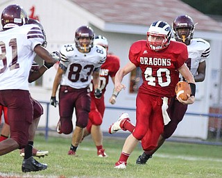IMG 8897:Niles Quarterback Stefan Yuhas (40) runs through the center of the Liberty defense while being run down by Tarik Muse (81) of Liberty during the second quarterÊof Friday nights matchup at Niles Mckinley High School in Niles. ÊDustin Livesay Ê| ÊThe Vindicator 8/31/12 ÊNiles, Ohio