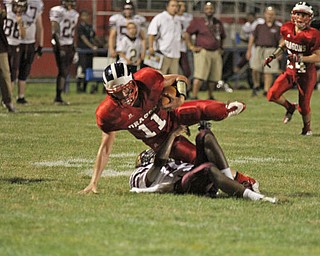 IMG 8981: John Cicero (11) of Niles Mckinley gets brought to the ground by Asim Please (14) of Liberty during the second half of Friday nights matchup at Niles Mckinley High School in Niles. ÊDustin Livesay Ê| ÊThe Vindicator 8/31/12 ÊNiles, Ohio