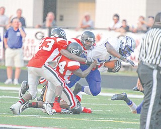 Hubbard’s Larry Scott (3) is stopped by Girard defenders during their game at Girard on Friday.