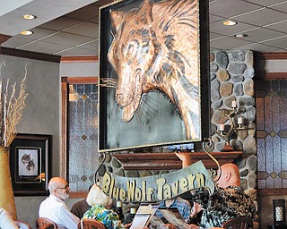 Patrons are greeted by a copper wolf in the dining area of the Blue Wolf Tavern.
