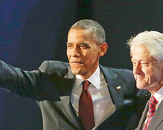 President Barack Obama waves with former President Bill Clinton after Clinton's speech to the Democratic National Convention in Charlotte, N.C., on Wednesday, Sept. 5, 2012.(AP Photo/Lynne Sladky)