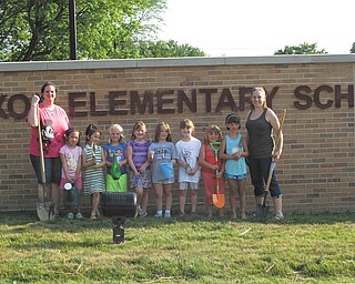 Daisy Girl Scout Troop 80777 of Columbiana, with nine members, planted day lilies at Joshua Dixon Elementary school, where they will be attending classes. The flowers can be seen from the main entrance. From the left are Troop Co-leader Kathy Kaszowski; Girl Scouts Chloe Gill, Mia Surgenivic, Rebekah Clark, Katrina Kaszowski, Elizabeth Siembida, Alaina Johnston, Abbie Passmore and Airianna Scullion; and Troop Leader Crystal Boggs. Absent from the picture is Chloe Loveland. The school principal, Kim Sharshan, donated the flowers for the girls to plant. Girls that are beginning first grade this year can contact Boggs at 330-482-9105 to join Girl Scouting. They will participate in the fall product sales fundraiser and begin selling cookies in December.