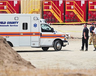 Police and fire offi cials tape off the area after an explosion at an Encana Corp. oil and natural-gas facility near Fort Lupton, Colo. Some offi cials in Colorado would like to keep drilling away from where residents live and work.