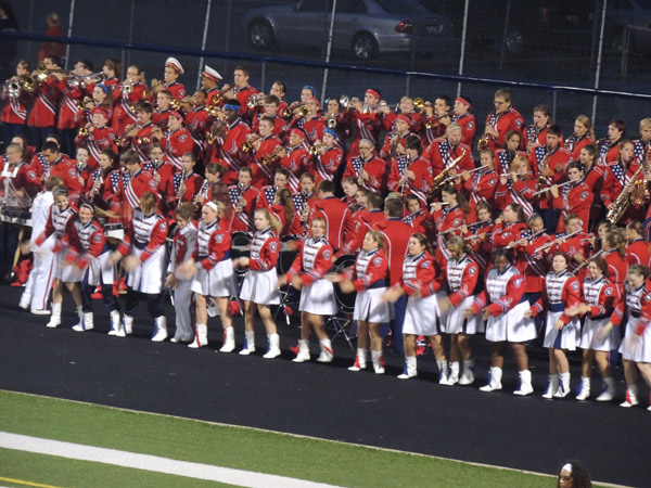 Flag, Rifle and color guard lines having fun cheering on the team
