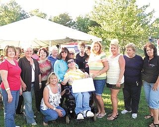 Members of the Warren Junior Women’s League recently donated $4,000 to the Life Enriching Activities Program, known as LEAP, which provides monthly social activities for teens and young adults who have handicaps and disabilities. Activities include movies, sports events, shopping, bowling, scrapbooking, gardening and dining out. Funds were raised at WJWL’s Taste of Trumbull, which took place in April at Eastwood Expo Center in Niles. Standing, from left, are WJWL members Shirley Wittenauer, Eddie Wolcott, Kellie Pope, Sandra Saluga, Cary Ann Koren, Renee Maiorca, Mary Theis, Dorie Harris, Jonnah Hetzel, Mary Lou Jarrett, Karen Margala, Dorothy Sideropolis and Jan Elliott. In the front row, from left, are Molly Halliday, Taste of Trumbull chairwoman, and Rocky Maiorca, LEAP participant.