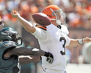 Cleveland Browns quarterback Brandon Weeden (3) has the ball knocked from his hand by Philadelphia Eagles defensive end Trent Cole in the first quarter of a game in Cleveland on Sunday. Weeden had one of the worst
debuts in NFL history, a 5.1 rating. Cleveland’s defense forced five turnovers but couldn’t get the one it needed to stop Michael Vick. It added up to another tough loss, but one that showed some promise for a young team.