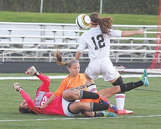 Canfi eld goalie Victoria Villano (02) and Howland’s Jordan Entler, middle, get tangled up as Canfield’s Sophia Mancini (12) tries to get control of the ball during the first half of Monday’s game at Canfield High School.