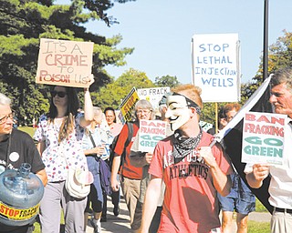 Protesters at an anti-fracking rally march from the The First Unitarian Universalist Church of Youngstown to the Stambaugh Auditorium. Alice Lynd, top, participated in the rally Wednesday.