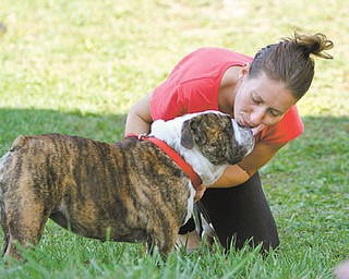 Mary Gump of Youngstown receives a kiss from Mabel at her home on the city’s West Side. The bulldog was reported stolen at the Bob Evans restaurant along Belmont Avenue on Aug. 14. Gump helped in the dog’s recovery and is housing Mabel until her owner, Brook Jillings of Boise, Idaho, arrives and reunites with her beloved pet sometime today.