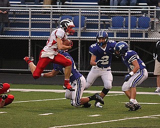 NICK MAYS l THE VINDICATOR (10) Chris Parry of Niles leaps past (44) Jake Aiello (2) Pat Hiznay and (34) Tad Duran during the first quarter of thier game in Poland. Niles vs Poland 09142012 Poland, Ohio