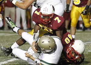 ROBERT K. YOSAY | THE VINDICATOR --..SACKED is #13 svsm Clayton Uecker behind the line by #7 CM Marlan Everson and#40 Todd Thorton - second quarter action ---Akron St Vincent St Mary @ Cardinal Mooney at YSU Stadium..(AP Photo/The Vindicator, Robert K. Yosay)