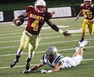 ROBERT K. YOSAY | THE VINDICATOR --..CM #4 Marcus McWilson as he breaks away from svsm #23 Nathan Bischof - as he heads for a first down #35 CM Anthony Dermotta Akron St Vincent St Mary @ Cardinal Mooney at YSU Stadium..(AP Photo/The Vindicator, Robert K. Yosay)