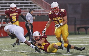 ROBERT  K.  YOSAY  | THE VINDICATOR --..Tripped at the line  svsm  #4 Franshon Bickley is brought down by CM #14 Marcus Penza as Cm #35  Anthon Dermotaa looks on during first quarter action at  Akron St Vincent St Mary @ Cardinal Mooney  at YSU Stadium..(AP Photo/The Vindicator, Robert K. Yosay)