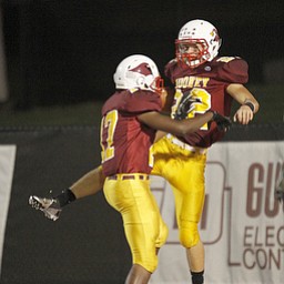 ROBERT K. YOSAY | THE VINDICATOR --..High five as #22 Mark Handel and #17 Quincy Jones celebrate mooney up by 20 to 3 ..Akron St Vincent St Mary @ Cardinal Mooney at YSU Stadium..(AP Photo/The Vindicator, Robert K. Yosay)