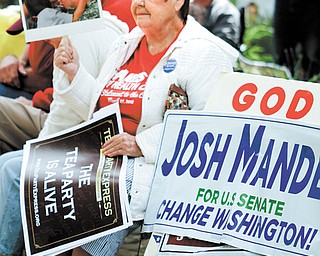 Lynne Yost of Canfield shows her support at the Tea Party Express national bus-tour rally on the Village Green in Canfield. The 21-day “Winning for America” tour, which was in the city Wednesday, is covering 25 battleground states.