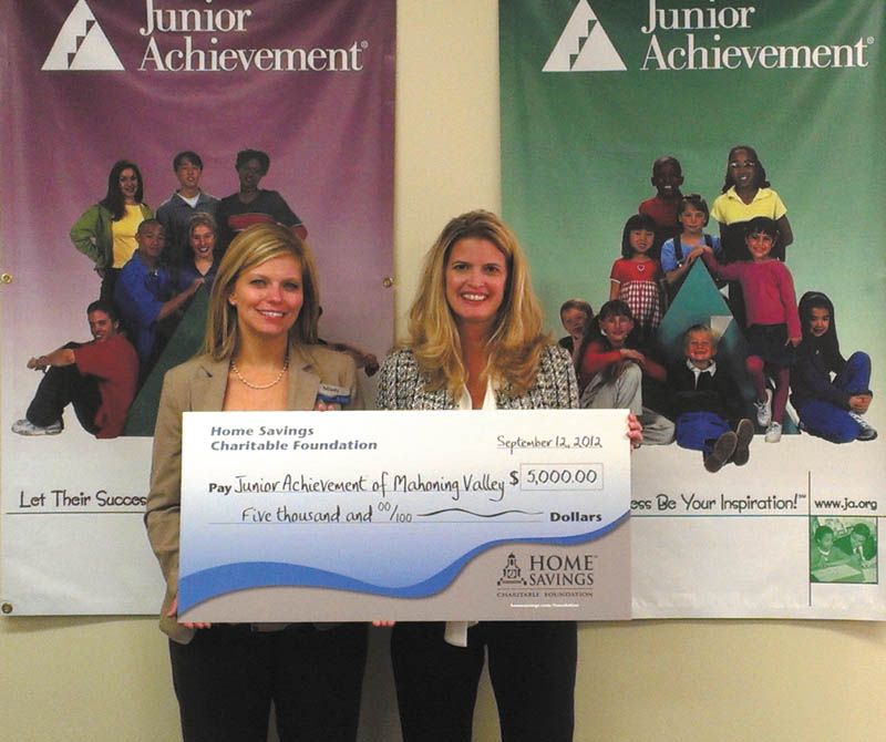 Mindy Wiesensee of Home Savings McCartney office, left, and Michele Merkel, president of Junior Achievement of Mahoning Valley, hold an oversized check for $5,000. Home Savings Charitable Foundation recently made the donation to Junior Achievement. JA volunteers teach young people in kindergarten through 12th grades about entrepreneurship. JAMV was formed in 1992 with the consolidation of JA of Trumbull County established in 1952, and JA of Youngstown Area established in 1953.  JAMV coordinates programs in Mahoning, Trumbull, Columbiana and Ashtabula counties.