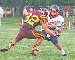 Warren JFK’s Dominic Naples (10) outmaneuvers Robert Seman (32) of South Range during their 2012 season opener at South Range High School. With a 4-0 record, the Eagles are off to their best start since 2006.