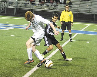 Canfield’s Kasey Montezari, right, and Poland’s Scott Marucci battle for control of the ball during an All-American Conference American Division soccer match Thursday night in Poland. The Cardinals controlled
the Bulldogs, 6-1.