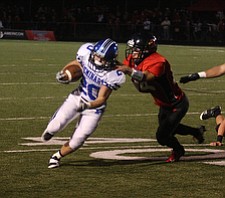 NICK MAYS l THE VINDICATOR (20) Ross Gould of Poland breaks away from (24) Luke Whittenberger for a touchdown in the second quarter of thier game in Canfield Friday night. poland vs canfield 09212012 canfield, ohio