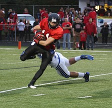 NICK MAYS l THE VINDICATOR (11) Jake Dawson of Canfield breaks away from (23) Adam Wollet during the first quarter of thier game in Canfield Friday night. poland vs canfield 09212012 canfield, ohio