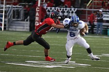 NICK MAYS l THE VINDICATOR  (6) Anthony Marchionda of Poland can't get away from (12) Drew Rogers during the first quarter of thier game in Canfield Friday night. poland vs canfield 09212012 canfield, ohio