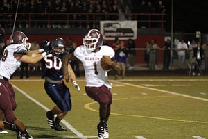 ROBERT K. YOSAY | THE VINDICATOR --..Bdm #1 Takes off for a first down run behing helped by #68 ( not in program and Blocking Fitch's #50 Ryan Sayers - Boardman vs Fitch @ Fitch ..(AP Photo/The Vindicator, Robert K. Yosay)