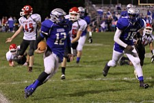 IMG 3565: Hubbard quarterback Brandon Harb (12) looks for an opening while running the ball up the sidelines during the second halfÊof Friday nights matchup against Struthers at Hubbard High School. ÊDustin Livesay Ê| ÊThe Vindicator Ê9/21/12 ÊHubbard, Ohio