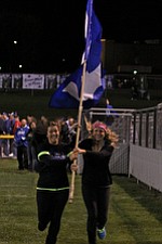 IMG 3619: Hubbard seniors Dana Takash (left) and Megan DeMaiolo (right) run with a flag with a H on it in celebration of a touchdown by the Hubbard High School football team during Friday nights matchup against Struthers mat Hubbard High School. ÊDustin Livesay Ê| ÊThe Vindicator Ê9/21/12 ÊHubbard, Ohio
