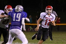 IMG 3643: Struthers quarterback Gary Muntean (12) gets a block by Nick Pollifrone (21) on Isiah Scott (19) of Hubbard during the second halfÊof Friday nights matchup at Hubbard High School. ÊDustin Livesay Ê| ÊThe Vindicator Ê9/21/12 ÊHubbard, Ohio