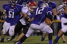 IMG 3666: Tommy Batron (73) of Struthers hits the ball causing a fumble on Hubbard quarterback Brandon Harb (12) during the second halfÊof Friday nights matchup at Hubbard High School. ÊDustin Livesay Ê| ÊThe Vindicator Ê9/21/12 ÊHubbard, Ohio