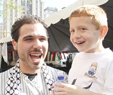 Mahammed Salman of Youngstown and his cousin Adam Omran of Canfield enjoy events at Arab American Festival of Youngstown Saturday in downtown Youngstown.