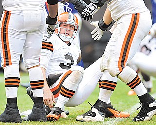 Cleveland Browns quarterback Brandon Weeden (3) is helped up after being knocked down by the Buffalo Bills defense in the fourth quarter of Sunday’s NFL game in Cleveland. The Browns were plagued by penalties, dropped passes, an inability to stop the run and turnovers, including two interceptions in the final four minutes as Weeden was trying to rally his team. The Browns fell 24-14.