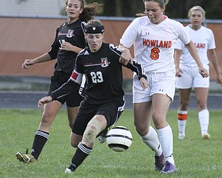 William D.Lewis The Vindicator  Canfield's Jen Morris (23) and Howland's Jenn Boyd (6)) go for the ball during Monday action at Howland. At left is Canfield's Emma Seybert(17).