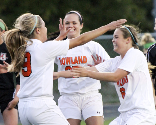 William D.Lewis The Vindicator Howland's Seyla Perez(9) gets congrats from Jenna Dorchock( 25) and Jenn Boyd(6) after scoring first goal during Monday action at Howland.
