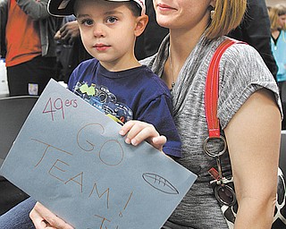 Tyler DeMoin, 4, and his mom, Marie, of Stuthers hold a sign welcoming the San Francisco 49ers to Akron Childrens Hospital of the Mahoning Valley on Monday. The team is spending the week in the valley before playing the Jets on Sunday.