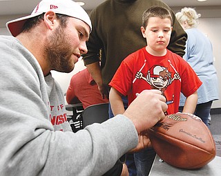 Stevie Pateras, 8, of Austintown gets a signature on his football from 49ers offensive lineman Al Netter.