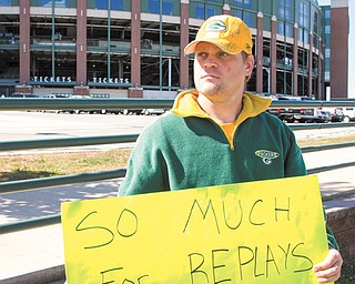 Green Bay Packers fan Mike LePak holds a sign in front of Lambeau Field along Lombardi Avenue, in Green Bay, Wis., Tuesday in protest of a controversial call in the Packers 14-12 loss to the Seattle Seahawks Monday night in Seattle. Just when it seemed that NFL coaches, players and fans couldn’t get any angrier, along came a fiasco that trumped any of the complaints from the weekend.