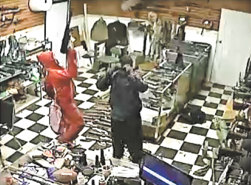 Video surveillance shows the breaking and entering at AAA Customs where dozens of high-powered weapons were taken. Police believe three people were involved in the theft and are hoping they can be identified from this still photo.