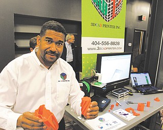 Ron Robinson, president and chief executive of 3DCAD Printer Inc., shows off some of the products made using the additive manufacturing process. Robinson joined several other private companies and universities Thursday at the opening of the National Additive Manufacturing Innovation Institute at 236 W. Boardman St.