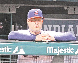 Cleveland Indians manager Manny Acta watches a game against the Detroit Tigers from the dugout at Progressive Field in Cleveland. The Indians announced Thursday — an off day before their final homestand — that Acta has been fired.