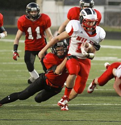ROBERT K. YOSAY | THE VINDICATOR --..#84 Canfield Kyle Nagy brings down #11 John Cicero of Niles after a first down during first quarter action - .. Niles at Canfield - Bob Dove Field ..(AP Photo/The Vindicator, Robert K. Yosay)