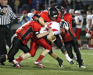 ROBERT K. YOSAY | THE VINDICATOR --..No where to go as Niles #40 Stefan Yuhas is corraled by Canfields 84 Kyle Nagy 11 Jake Dawson and 32 Nick Annichenni -- at the line during second quarter action ---Niles at Canfield - Bob Dove Field ..(AP Photo/The Vindicator, Robert K. Yosay)