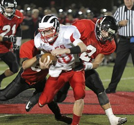 ROBERT K. YOSAY | THE VINDICATOR --..Brought down after a first down during second quarter action - is Niles #40 StefanYuhas - by Canfields #84 Kyle Nagy and #2 Nick Annichenni - after he got the first down ..Niles at Canfield - Bob Dove Field ..(AP Photo/The Vindicator, Robert K. Yosay)