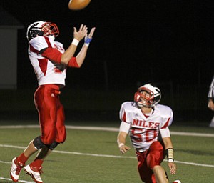 ROBERT K. YOSAY | THE VINDICATOR --..After a tipped ball Niles #0 Andres Sheets hauls in the tip - as #50 Niles Jake Forward watches. the play was rulled dead - Niles at Canfield - Bob Dove Field ..(AP Photo/The Vindicator, Robert K. Yosay)
