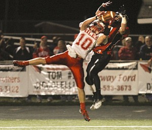 ROBERT K. YOSAY | THE VINDICATOR --..Breaking up the pass and intercepting in the endzone is Niles #10 Chris Parry as the pass was intended for #11 Jake Dawson - during third quarter action Niles at Canfield - Bob Dove Field ..(AP Photo/The Vindicator, Robert K. Yosay)